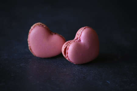 heart-shaped macaroons on dark background. Macaroons Heart. Valentines Day.の写真素材