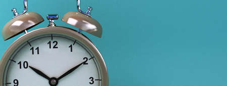 vintage alarm clock on light blue color background. 3d renderingの写真素材