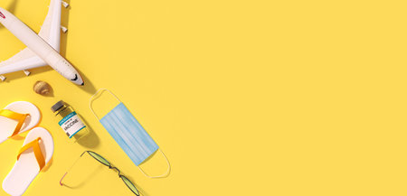 Corona vaccination concept with airplane, mask and vaccination bottle as background from above, 3d renderingの写真素材