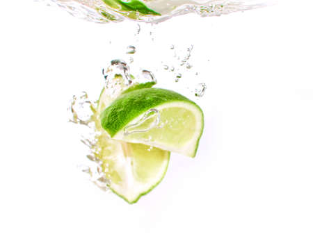 lime and lemon splashing water isolated on white backgroundの写真素材