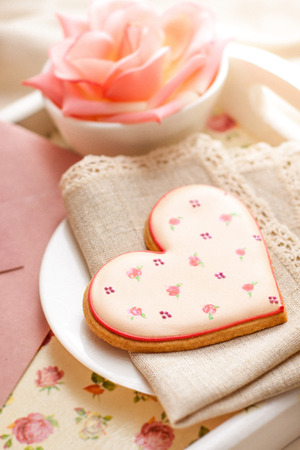 Romantic breakfast in bed. Breakfast tray with heart shaped biscuit, drink sparkling, rose and envelope. Perfect for Valentines, anniversary, birthday, wedding day or engagement.の写真素材