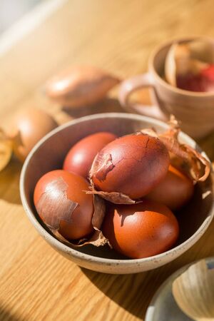 Bowl of eggs dyed red in onion skins. Ukrainian Easter tradition. Sustainable natural dye.の写真素材
