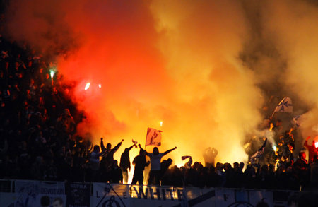 Kyiv, Ukraine - November 21, 2010: FC Dynamo Kyiv supporters burn flares during the game against FC...