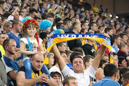 LVIV, UKRAINE - OCTOBER 12, 2014: Ukrainian fans support their team during the UEFA EURO 2016 Qualifying game between Ukraine and Macedonia on Lviv Arenaのeditorial素材