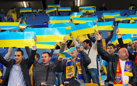 LVIV, UKRAINE - OCTOBER 12, 2014: Ukrainian fans support their team during the UEFA EURO 2016 Qualifying game between Ukraine and Macedonia on Lviv Arenaのeditorial素材