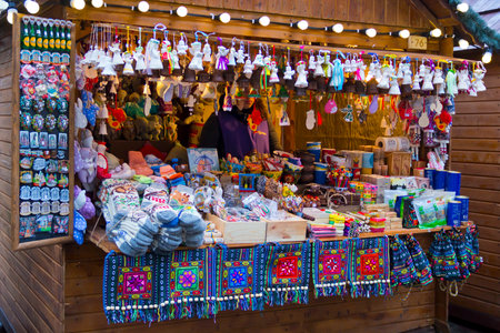 LVIV, UKRAINE - DECEMBER 11, 2016: Woman sells souvenirs on Christmas holiday market on the central square of Lviv (Market square)のeditorial素材