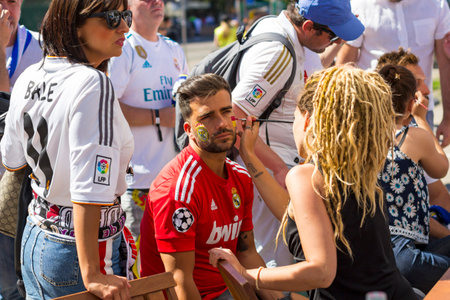 KYIV, UKRAINE - MAY 26, 2018: Real Madrid football fans paint faces waiting for the UEFA Champions League Final match between Real Madrid and Liverpoolのeditorial素材