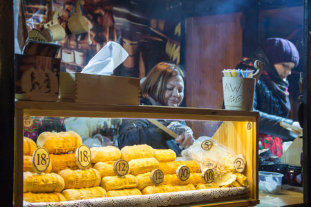 WROCLAW, POLAND - DECEMBER 7, 2017: Food stall with traditional polish smoked cheese oscypek on Christmas marketのeditorial素材