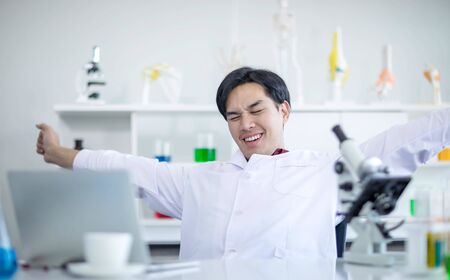 Asian male doctor relaxed with arms outstretchedの写真素材