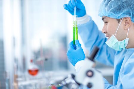 Asian scientists wear protective clothing while testing herbal medicines in the laboratory. Concepts, laboratory research on antiviral drugs, Covid 19 virusの写真素材