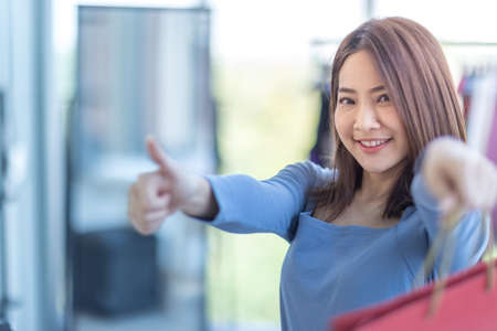 Beautiful Asian women are shopping in stores. and smile at the cameraの写真素材