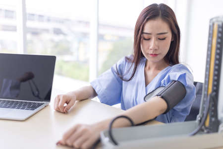 Doctor measuring arterial blood pressure for asian women patient. Concept Health care in hospitalの写真素材