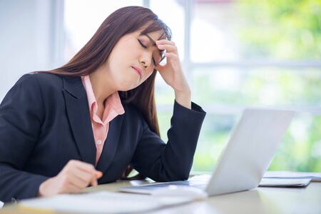 Beautiful Asian women disappointed with the job project in office. Asian employee, and office staff conceptの写真素材