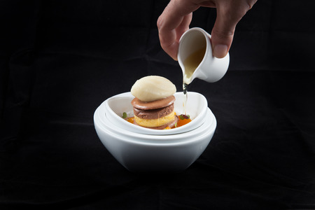pouring syrup on to icecreamの写真素材