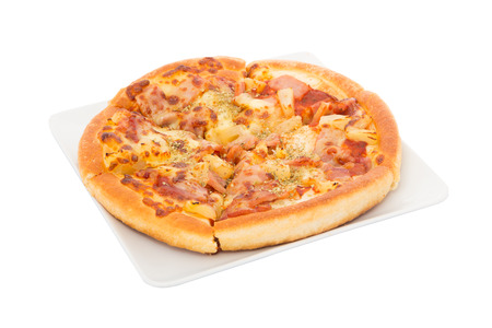 Hawaiian Pizza on white dish with ham, bacon, cheese andの写真素材