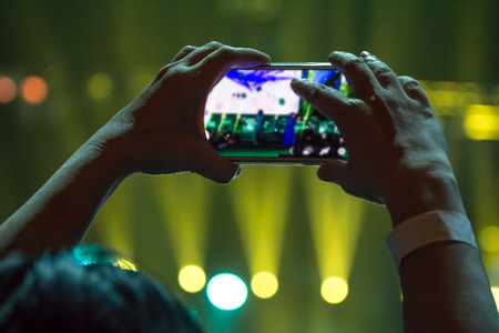 Selective focus to hands of Someone record the funny in Live Concert with mobile