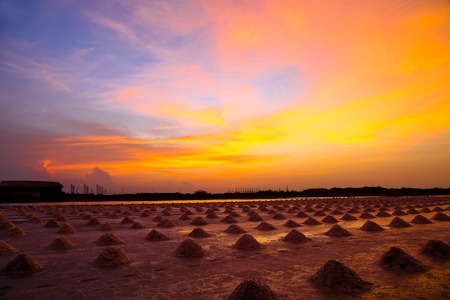 Beautiful landscape with color of twilight after dawn and many row of salt pile in salineの写真素材