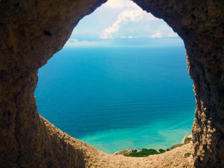 sea view through the rock on a summer sunny dayの写真素材