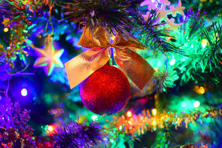 christmas toy ball on a garland-decorated treeの写真素材