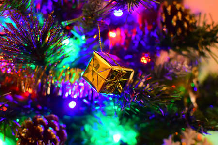 Christmas toy on a Christmas tree decorated with a garlandの写真素材
