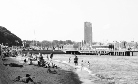 GDYNIA, POLAND- JULY 4, 2009: Crowd on the beach during the feast of first days of holiday against Sea Towers the biggest and most expensive investment since years.のeditorial素材