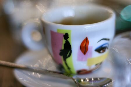 Detail of espresso mug, modern colorful design, saucer and teaspoon, lips, eyeの写真素材