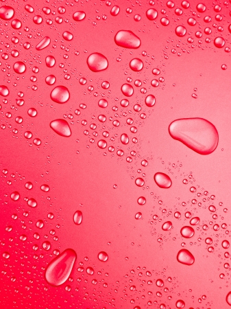 red background of beautiful water drops の写真素材