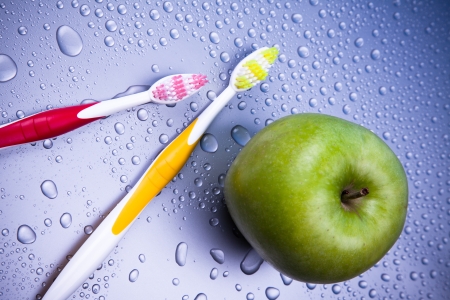 Oral hygiene with apple and toothbrushの写真素材