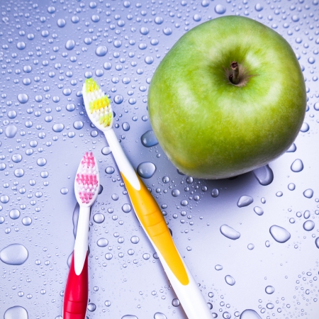 Oral hygiene with apple and toothbrushの写真素材