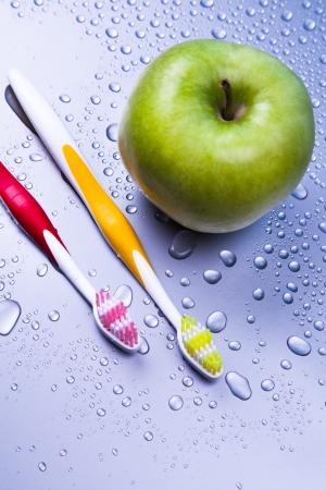 Oral hygiene with apple and toothbrushの写真素材