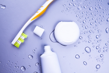 Toothbrush, toothpaste and dental floss with waterdropsの写真素材