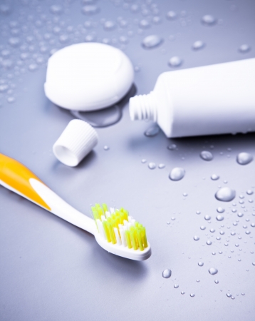 Toothbrush, toothpaste and dentalfloss with waterdropsの写真素材
