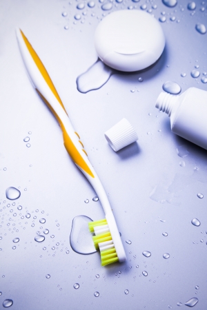 Toothbrush, toothpaste and dental floss with waterdropsの写真素材