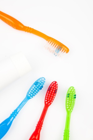Four colorful toothbrushes and a toothpasteの写真素材