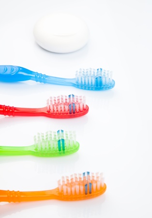 Four colorful toothbrushes and a dentalflossの写真素材