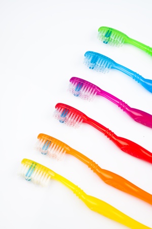 Six colorful toothbrushes in a lineの写真素材