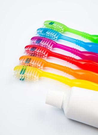 Six colorful toothbrushes and toothpasteの写真素材