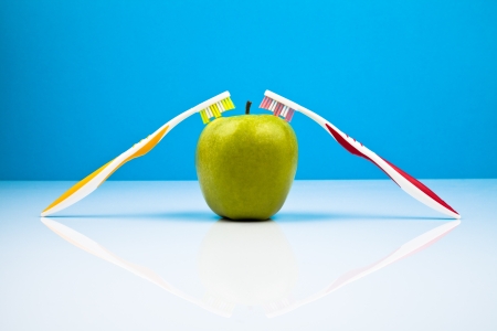 toothbrushes and an appleの写真素材