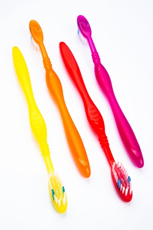 Four colorful toothbrushes in a lineの写真素材