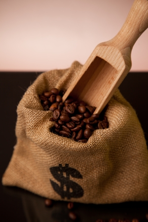Burlap sack of coffee beans with wooden scoopの写真素材