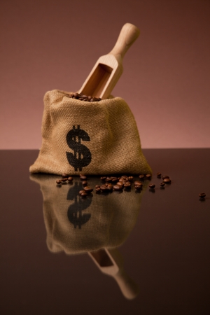 Burlap sack of coffee beans with wooden scoopの写真素材