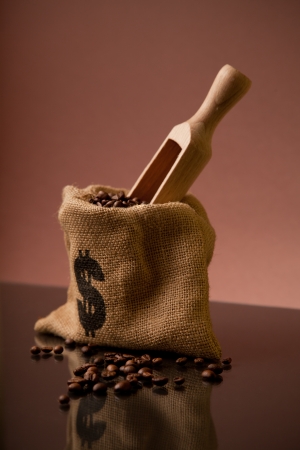 Burlap sack of coffee beans with wooden scoopの写真素材