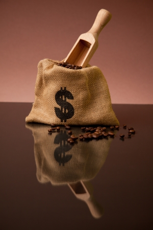 Burlap sack of coffee beans with wooden scoopの写真素材