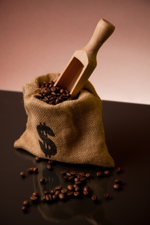 Burlap sack of coffee beans with wooden scoopの写真素材