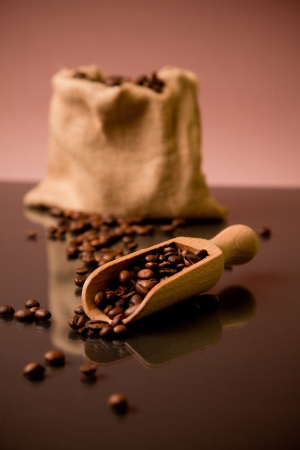 Burlap sack of coffee beans with wooden scoopの写真素材