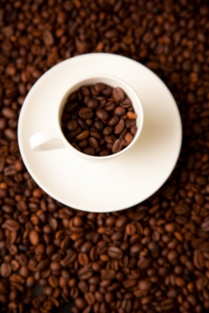 cup of coffee on roasted coffee beansの写真素材