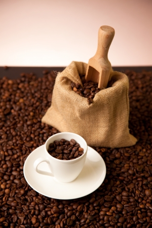 cup of coffee and burlap sack on roasted coffee beansの写真素材