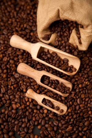 Wooden shovels full of coffee with burlap sackの写真素材