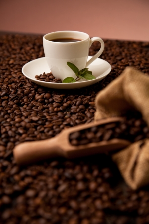 cup of coffee on roasted coffee beansの写真素材