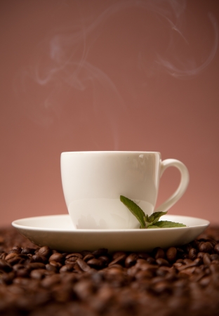 cup of coffee on roasted coffee beansの写真素材